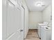 Functional laundry room with full-size washer and dryer, door to outside at 15031 N 37Th Ave, Phoenix, AZ 85053