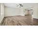 Open-concept living room featuring wood floors and a ceiling fan at 15031 N 37Th Ave, Phoenix, AZ 85053