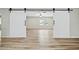 Bright living room featuring wood floors and sliding barn doors at 15031 N 37Th Ave, Phoenix, AZ 85053