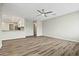 Bright living room with an open floorplan, ceiling fan, and wood-look flooring at 15031 N 37Th Ave, Phoenix, AZ 85053