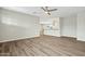 Open floor plan with wood-look flooring and a view into the spacious kitchen at 15031 N 37Th Ave, Phoenix, AZ 85053