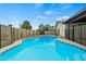 Inviting in-ground pool, set within a secure fenced area, complemented by desert landscaping at 15031 N 37Th Ave, Phoenix, AZ 85053