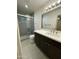Modern bathroom with a shower, gray tiling, and dark cabinetry at 1533 W 7Th St, Tempe, AZ 85281