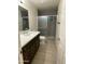 Modern bathroom featuring a sleek vanity with dark wood cabinets and a walk-in shower with gray tile at 1533 W 7Th St, Tempe, AZ 85281