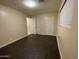 Bedroom with wooden flooring, a large window, and neutral paint colors at 1533 W 7Th St, Tempe, AZ 85281