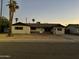 Charming single-story home featuring a quaint front porch, mature palm trees, and desert landscaping at 1533 W 7Th St, Tempe, AZ 85281
