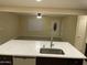 Open kitchen with an island with a stainless steel sink and bar seating overlooking the living room at 1533 W 7Th St, Tempe, AZ 85281