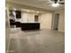 Open-concept living space seamlessly connects to kitchen area with a spacious island and tile flooring at 1533 W 7Th St, Tempe, AZ 85281