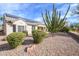Backyard showcasing desert landscaping, solar panels, and a covered patio, blending sustainability with outdoor enjoyment at 15655 W Bethesda Ct, Surprise, AZ 85374