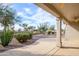 Inviting backyard patio area with desert landscaping, a covered patio and fan, perfect for relaxing outdoors at 15655 W Bethesda Ct, Surprise, AZ 85374