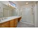 Bright bathroom with a large vanity, ample counter space, and a glass-enclosed shower at 15655 W Bethesda Ct, Surprise, AZ 85374