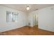 Spacious bedroom featuring hardwood floors, a ceiling fan, and access to a bathroom at 15655 W Bethesda Ct, Surprise, AZ 85374