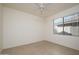 Comfortable bedroom with tile floors, a ceiling fan, and a window with vertical blinds at 15655 W Bethesda Ct, Surprise, AZ 85374