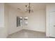 Cozy dining room with a decorative chandelier, complemented by natural light through large windows at 15655 W Bethesda Ct, Surprise, AZ 85374