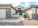 Inviting front entrance featuring a walkway leading to the front door, desert landscaping, and neutral colors at 15655 W Bethesda Ct, Surprise, AZ 85374