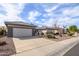 Charming single-story home featuring a well-manicured desert landscape, neutral tones, and a two car garage at 15655 W Bethesda Ct, Surprise, AZ 85374