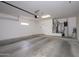 Large garage with cement floors, a water heater, and storage space at 15655 W Bethesda Ct, Surprise, AZ 85374