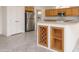 Kitchen featuring stainless steel appliances, light wood cabinets, and custom wine rack detailing at 15655 W Bethesda Ct, Surprise, AZ 85374