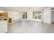 Bright living room with tile flooring, ceiling fans, sliding glass door, and natural light at 15655 W Bethesda Ct, Surprise, AZ 85374