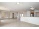 Bright living room with tile flooring, ceiling fans, adjacent kitchen, and natural light at 15655 W Bethesda Ct, Surprise, AZ 85374