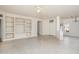 Bright living room with tile flooring, a ceiling fan, an adjacent dining area, and natural light at 15655 W Bethesda Ct, Surprise, AZ 85374