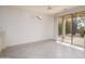 Well-lit living area featuring neutral walls and glass doors leading to an outdoor space at 15655 W Bethesda Ct, Surprise, AZ 85374