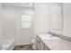 Clean bathroom featuring a tub, neutral vanity with integrated sink and modern fixtures at 164 S Oak Rd, Maricopa, AZ 85139