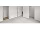 A bedroom with neutral carpet and paint is brightened by multiple entryways at 164 S Oak Rd, Maricopa, AZ 85139