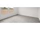 This bright bedroom includes a light window and neutral carpet that enhances the view at 164 S Oak Rd, Maricopa, AZ 85139