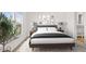 Serene bedroom boasts a comfortable bed with soft linens, complemented by matching nightstands and artistic decor at 164 S Oak Rd, Maricopa, AZ 85139