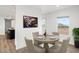 Cozy dining area with a round table set for four, showcasing bright natural light and stylish decor at 164 S Oak Rd, Maricopa, AZ 85139
