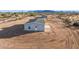 A modern desert home with a concrete entryway and monochromatic exterior at 164 S Oak Rd, Maricopa, AZ 85139