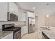 Modern kitchen features stainless steel appliances and granite countertops at 17870 W Hadley St, Goodyear, AZ 85338