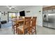 Cozy dining area with wood table, four chairs, and a ceiling fan, adjacent to the kitchen at 18230 E El Viejo Desierto --, Gold Canyon, AZ 85118