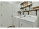 Functional laundry room with wooden shelving, washer, and dryer at 18230 E El Viejo Desierto --, Gold Canyon, AZ 85118