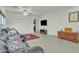 Open-concept living room with tiled floors, ceiling fan, and comfortable leather seating at 18230 E El Viejo Desierto --, Gold Canyon, AZ 85118