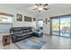Comfortable living room featuring a leather sofa, ceiling fan and sliding glass door to the outside at 18230 E El Viejo Desierto --, Gold Canyon, AZ 85118