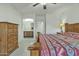 Bright main bedroom showcasing a wooden dresser, lamps, and colorful patterned quilt at 18230 E El Viejo Desierto --, Gold Canyon, AZ 85118