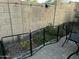 Backyard view featuring a fenced-in garden with mature shrubs and desert landscape elements at 1919 E Gary Way, Phoenix, AZ 85042