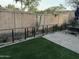 Backyard with artificial grass, desert plants and a dining area, perfect for outdoor enjoyment at 1919 E Gary Way, Phoenix, AZ 85042