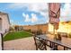 Backyard featuring a covered dining area, lush green lawn, and fenced perimeter at 1919 E Gary Way, Phoenix, AZ 85042