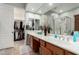 The primary bathroom features a double sink vanity with a large mirror and walk in closet at 1919 E Gary Way, Phoenix, AZ 85042