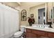 Bright bathroom features a decorative mirror, wood-look vanity, framed mirror, and neutral color scheme at 1919 E Gary Way, Phoenix, AZ 85042