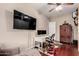 Bedroom area featuring a wall-mounted television, workspace, hardwood floors, and neutral color scheme at 1919 E Gary Way, Phoenix, AZ 85042