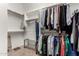 Walk-in closet with custom built-in shelving and clothing racks for organization and storage at 1919 E Gary Way, Phoenix, AZ 85042