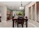 Charming dining area with a dark wood table and chairs, complemented by a view into the kitchen at 1919 E Gary Way, Phoenix, AZ 85042