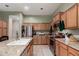 Well-lit kitchen featuring stainless steel appliances, granite countertops, and wood cabinetry at 1919 E Gary Way, Phoenix, AZ 85042