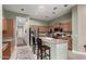 Bright, open kitchen with an island, granite countertops, stainless steel appliances and wood cabinets at 1919 E Gary Way, Phoenix, AZ 85042