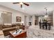 Open-concept living area with a sectional sofa, wooden coffee table, and view into the dining area at 1919 E Gary Way, Phoenix, AZ 85042