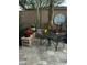 A cozy patio with dining set, vibrant potted plants, and desert landscaping for outdoor enjoyment at 1919 E Gary Way, Phoenix, AZ 85042